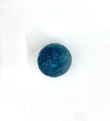 Single round dark teal sea glass ornament with textured surface and central hole, shown on white background.