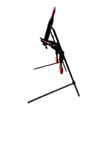 Black steel centerfire reset target with red circular reset plates and angled support legs against a black background