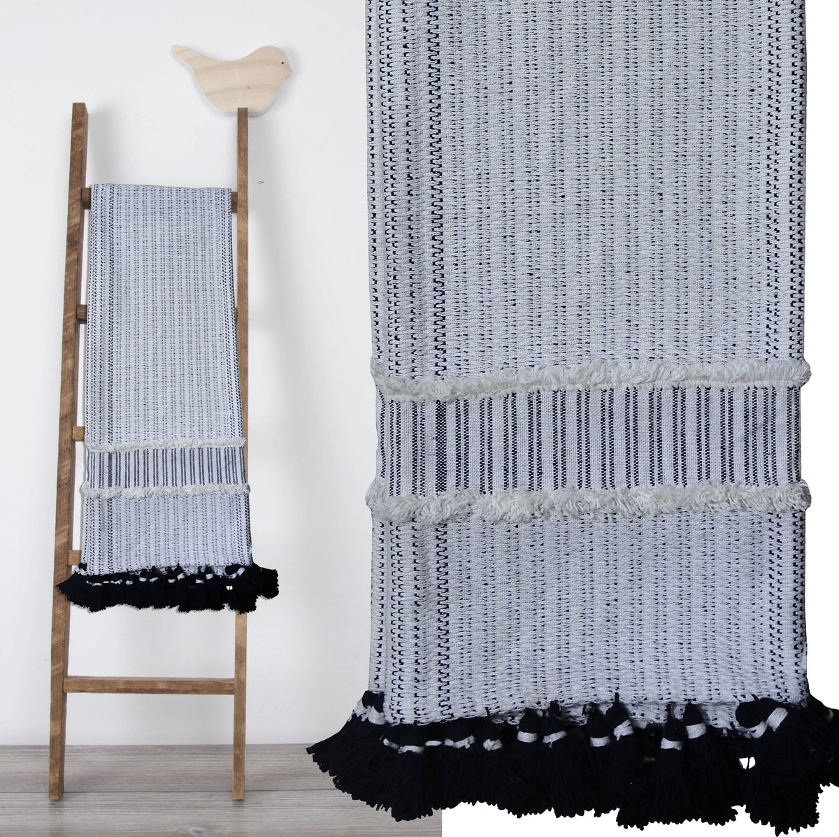 Hand loom woven textured throw in black and off-white with horizontal stripes and fringed edges, draped over a wooden ladder with a bird decoration on top.