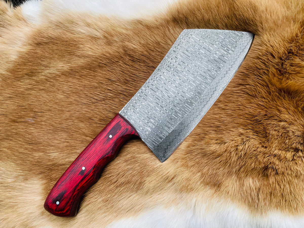 Custom Damascus steel cleaver with red handle showing blade and grip
