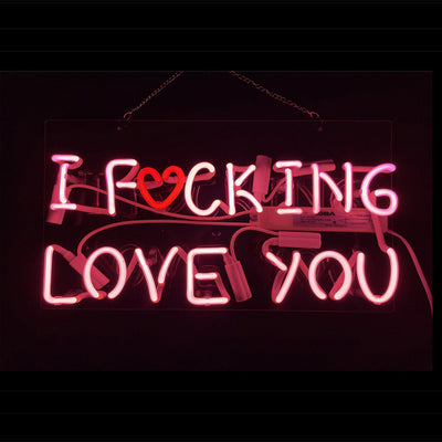 Pink neon sign reading 'I Fucking Love You' mounted on a wall with a metal chain