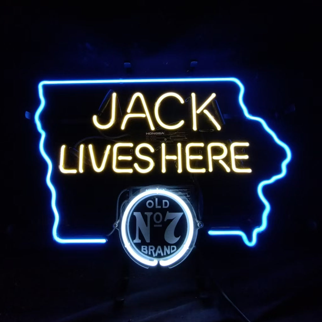 Neon sign with bright yellow text 'JACK LIVES HERE' inside a blue neon outline of Iowa state, featuring a white circular Old No 7 Brand logo below the text.