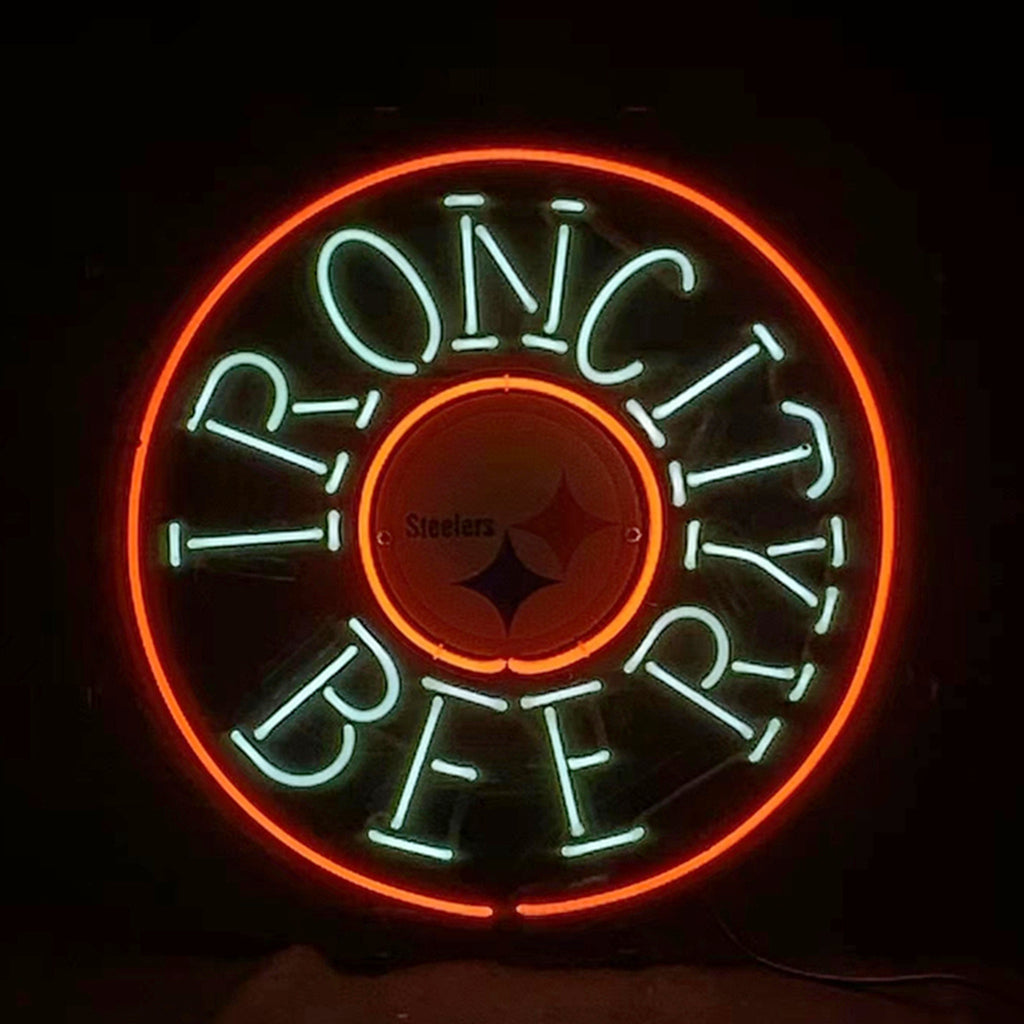 Circular neon sign with red outer ring and light blue text reading 'IRON CITY BEER' surrounding a small circle featuring the Pittsburgh Steelers logo.