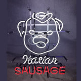 White neon outline of a smiling pig face with red neon text 'SAUSAGE' below and cursive white text 'Italian' above on a black background with metal mounting frame.