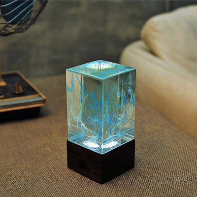 Handcrafted resin table lamp with ocean-inspired colors and warm white LED light