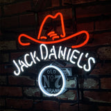 Neon sign with red outline of a cowboy hat above white cursive 'Jack Daniel's' text and circular 'Old No 7 Brand' logo on a dark brick wall.