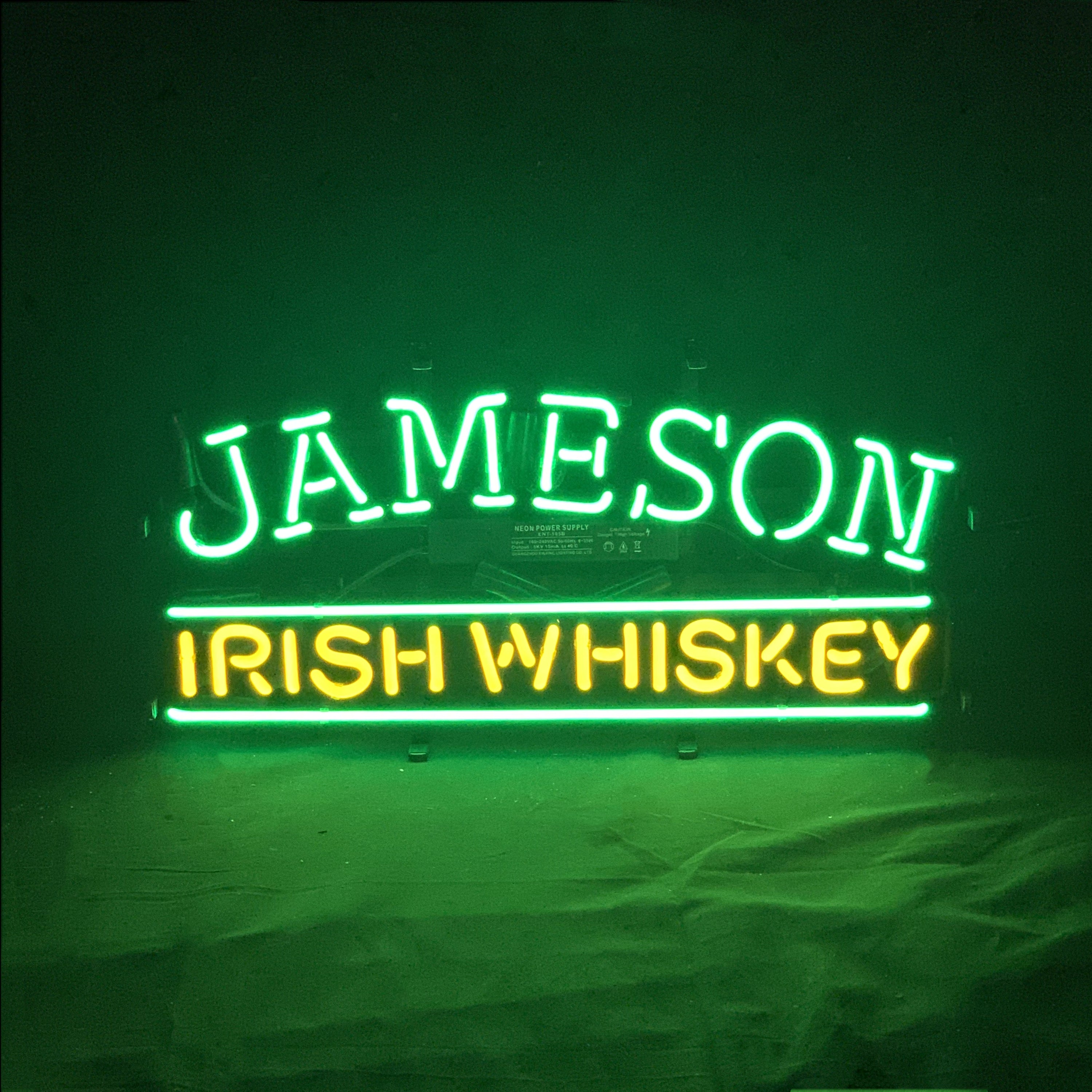 Jameson Irish Whiskey Neon Sign with glowing green and white tubes on a metal grid backing