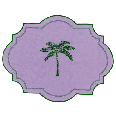 Set of four lilac linen placemats edged with emerald green embroidery featuring a palm tree motif