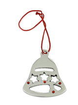 Set of eight silver jingle bell Christmas tree ornaments with red ribbons hung on branches