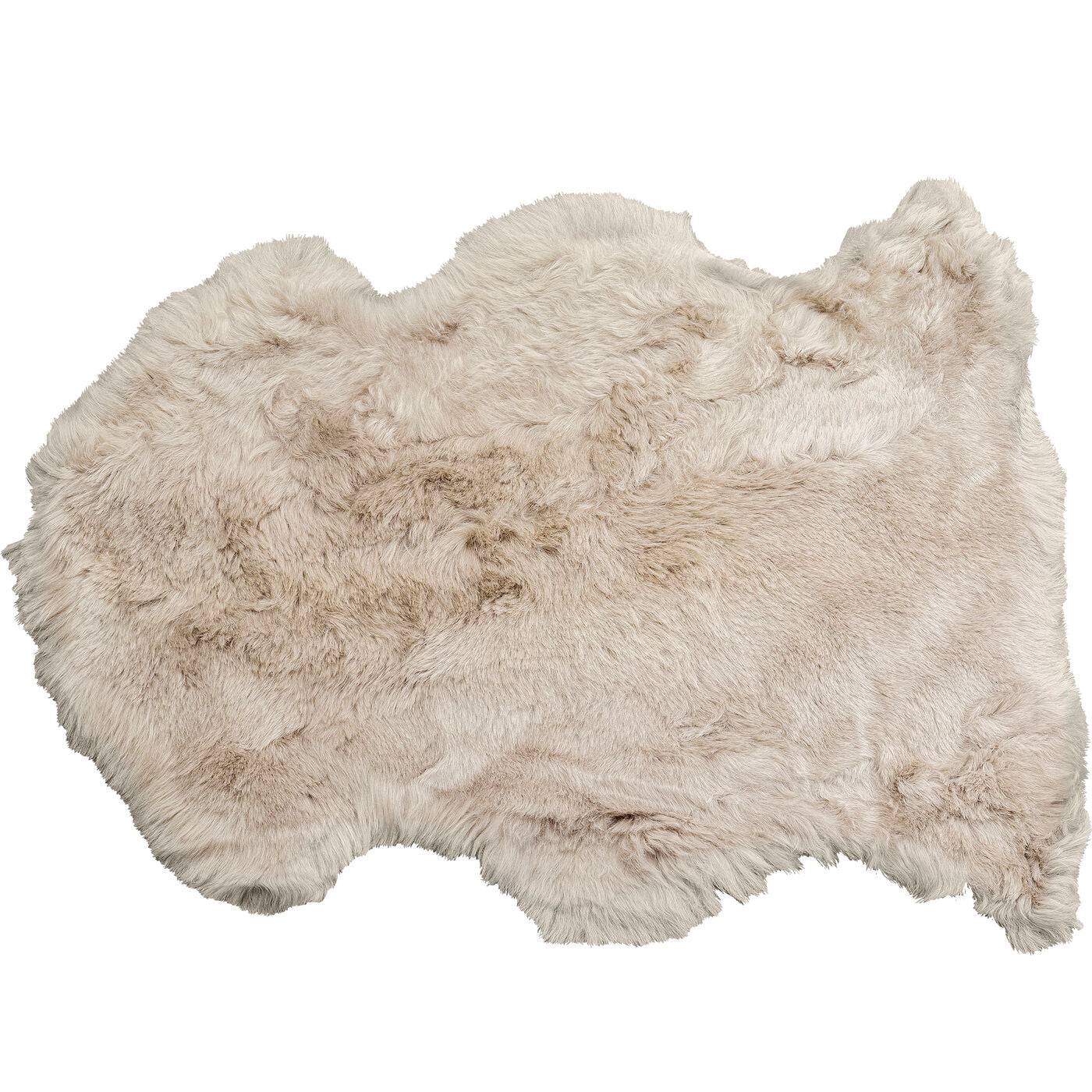 Lambskin Heidi Grey 65x85cm draped over a sofa showcasing soft, grey tones and plush texture