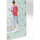 Close-up of a decorative picture frame corner with a pale blue background and gold geometric sunburst pattern, displaying a photo of a woman in a red sweater.