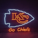 Neon sign featuring a white arrowhead outline with red interlocking KC letters inside and orange text saying 'Go Chiefs' below on a dark background.