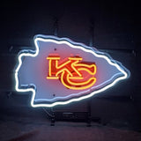Neon sign shaped like an arrowhead with white outline and red interlocking KC letters inside, glowing against a dark background.