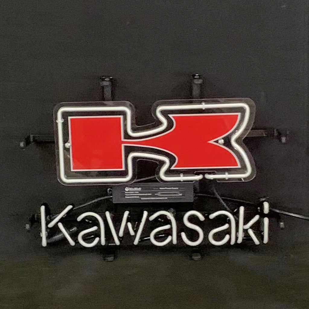 Neon sign with a red stylized 'K' logo above the white neon cursive lettering spelling 'Kawasaki' on a black background.