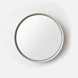 Round wall mirror with a slim, smooth metal frame casting a soft shadow on a white background, shown from a direct front view.