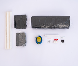 Assembly kit with black plastic parts, four white rods, a blue and yellow valve, a red handle valve, and a small instruction booklet arranged on a white background.