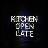 White neon sign displaying the words 'KITCHEN OPEN LATE' in uppercase letters against a dark background.