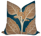 Square pillow with a deep teal background featuring large, intricate beige leaf patterns with dotted and scalloped details.