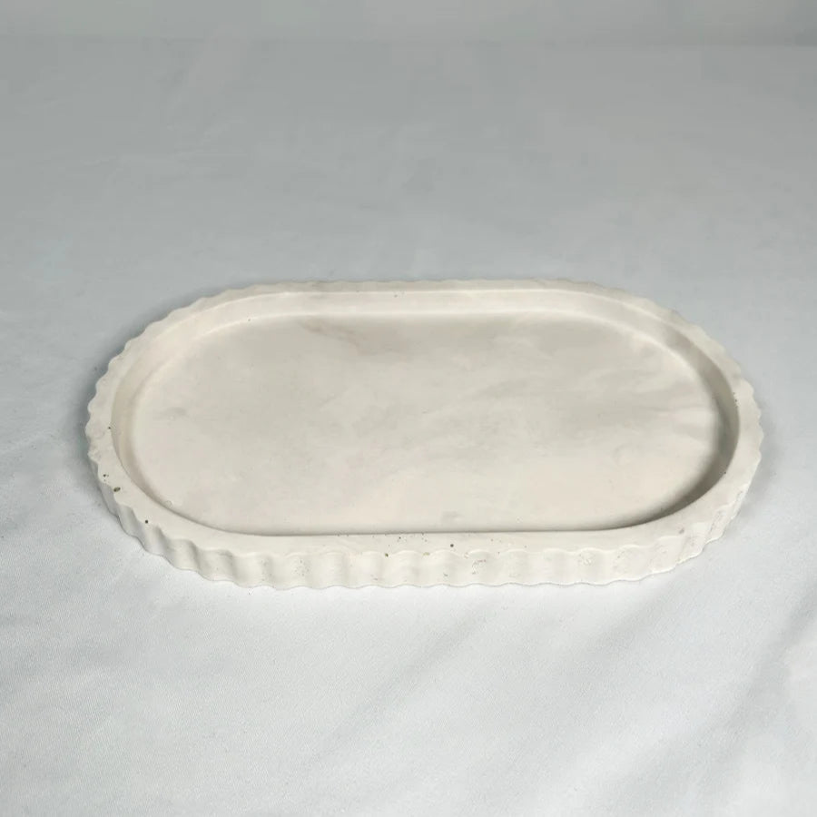 White ceramic oval platter on a gray background