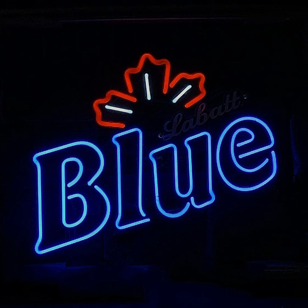 Neon sign with the word 'Blue' in bright blue and a red maple leaf outline above it, against a dark background.