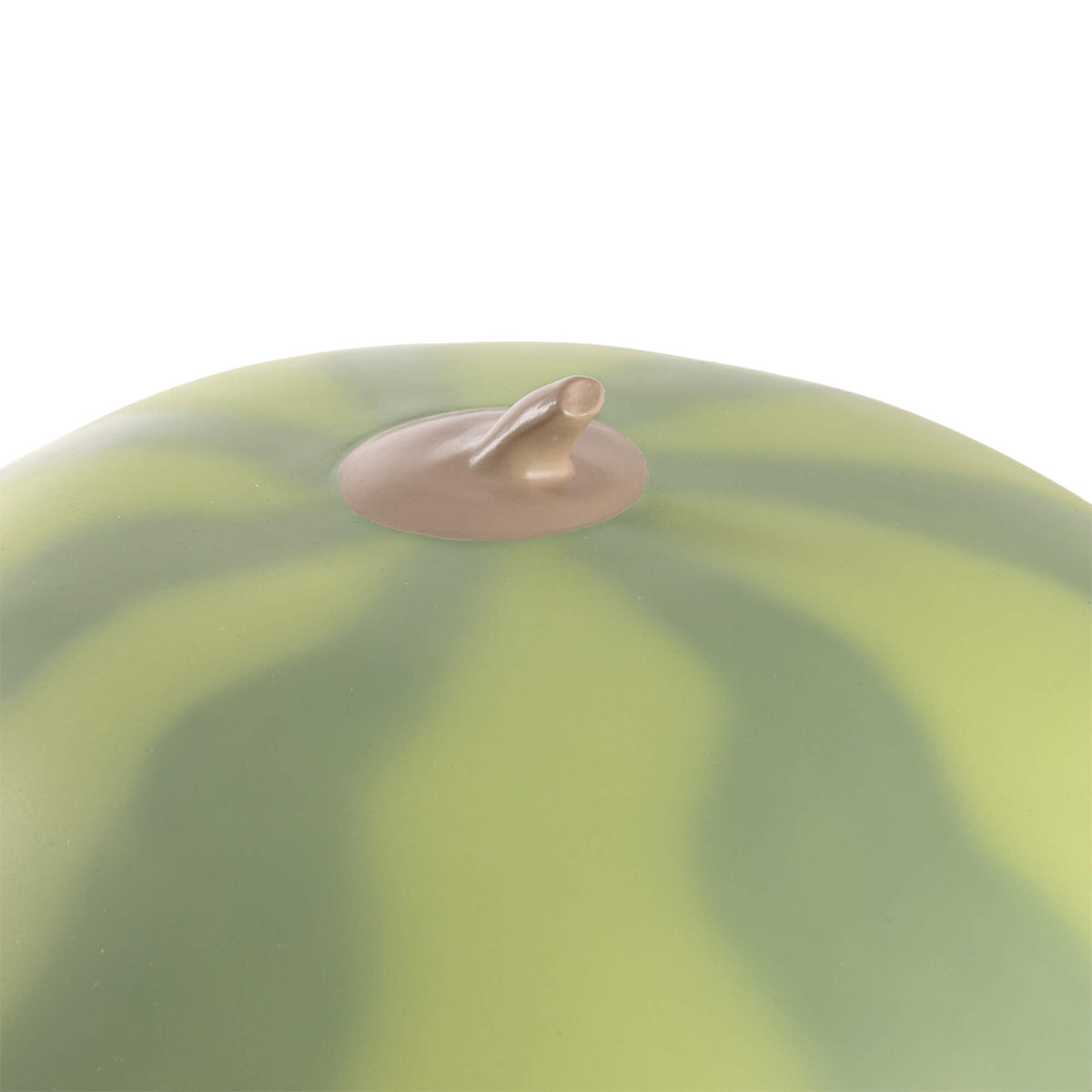 Close-up of the top of a round lamp resembling a watermelon with alternating light and dark green stripes and a small brown stem at the center.