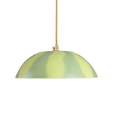 Dome-shaped ceiling lamp shade with alternating light green and darker green stripes, suspended by a yellow fabric-covered cord and gold fixture.