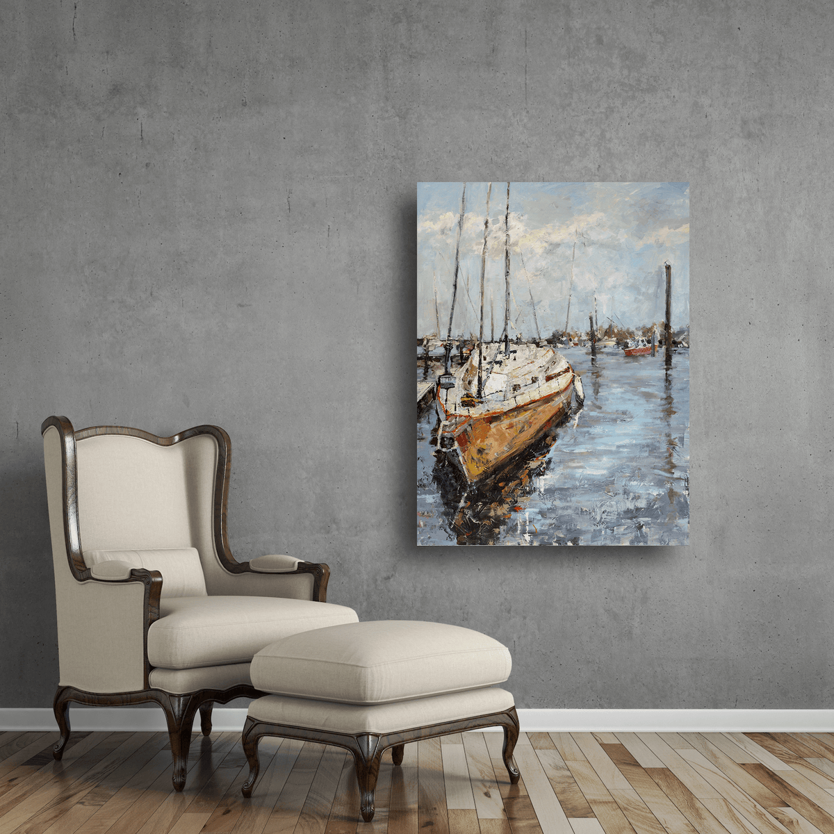 Canvas art depicting a sailboat docked at a harbor with reflections on water and a cloudy sky, mounted on a gray wall beside a beige armchair and ottoman.