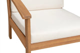 Close-up of Lio wooden armchair's armrest and white seat cushion, highlighting smooth wood grain and simple, straight lines in light brown finish.