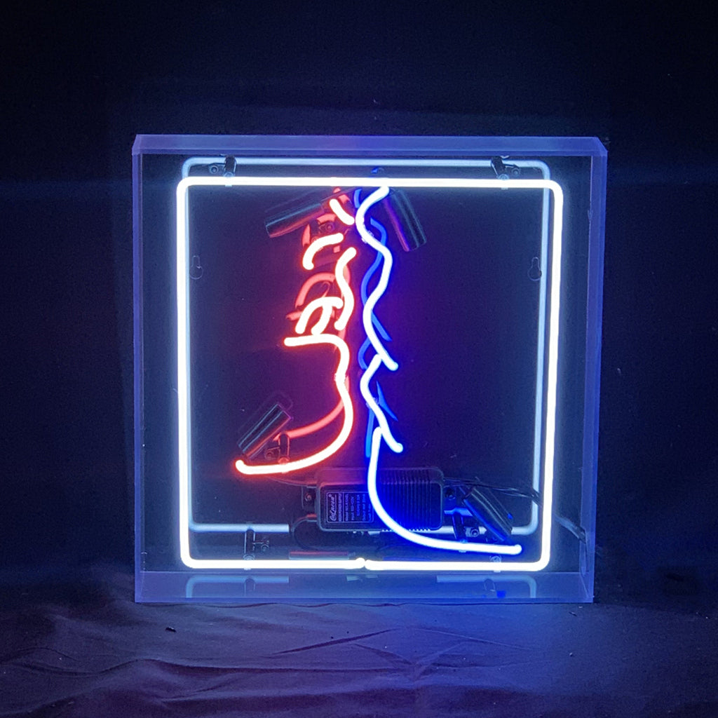 Love Kiss Neon Light Sign glowing with bright red neon on square acrylic backing hanging indoors