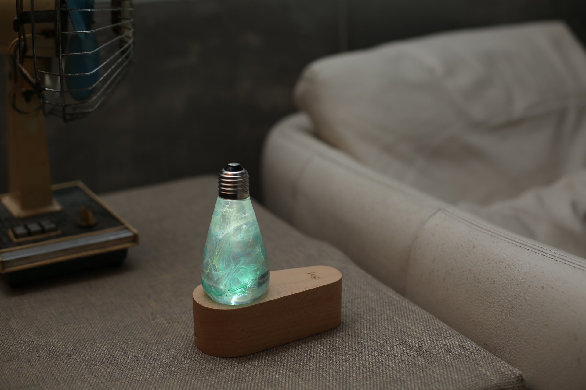 EP Light Spring Resin LED Bulb with green resin design on wooden base