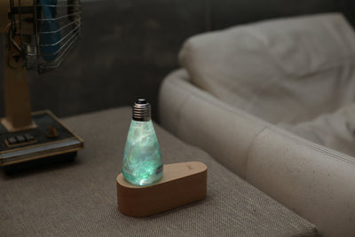 EP Light Spring Resin LED Bulb with green resin design on wooden base