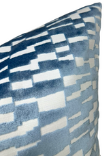 Velvet pillow cover in marine blue with abstract stepped rectangular pattern in varying shades of blue and white, shown at an angle highlighting texture and color contrast.