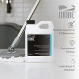White 1-quart jug of MORE Acidic Cleaner with black cap on tiled floor near mop head, with text highlighting grout haze removal, concentrated formula, water-based and unscented features.