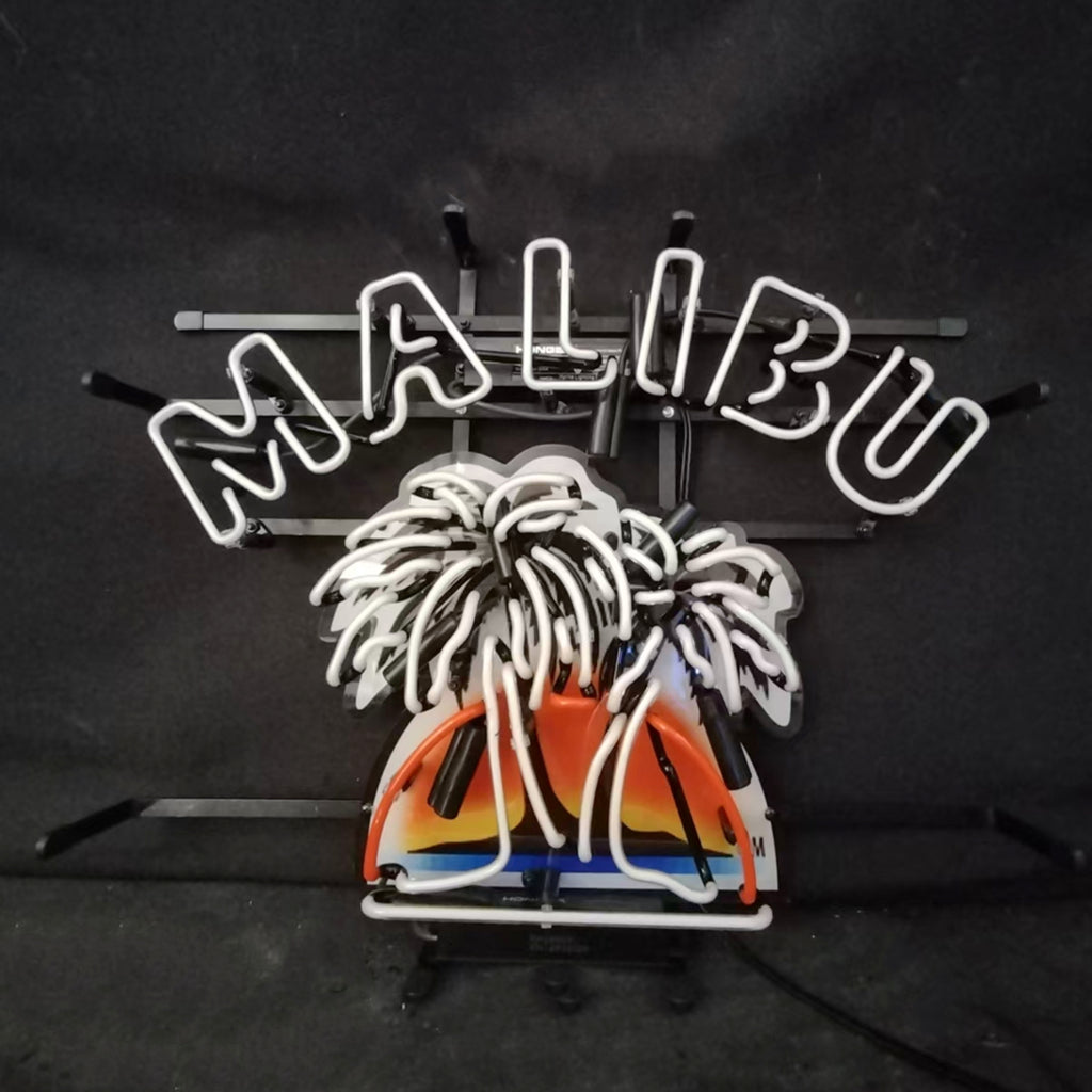 Neon sign with white 'MALIBU' text above two white palm trees and a sunset shaped in orange, yellow, and blue neon lights against a black background.