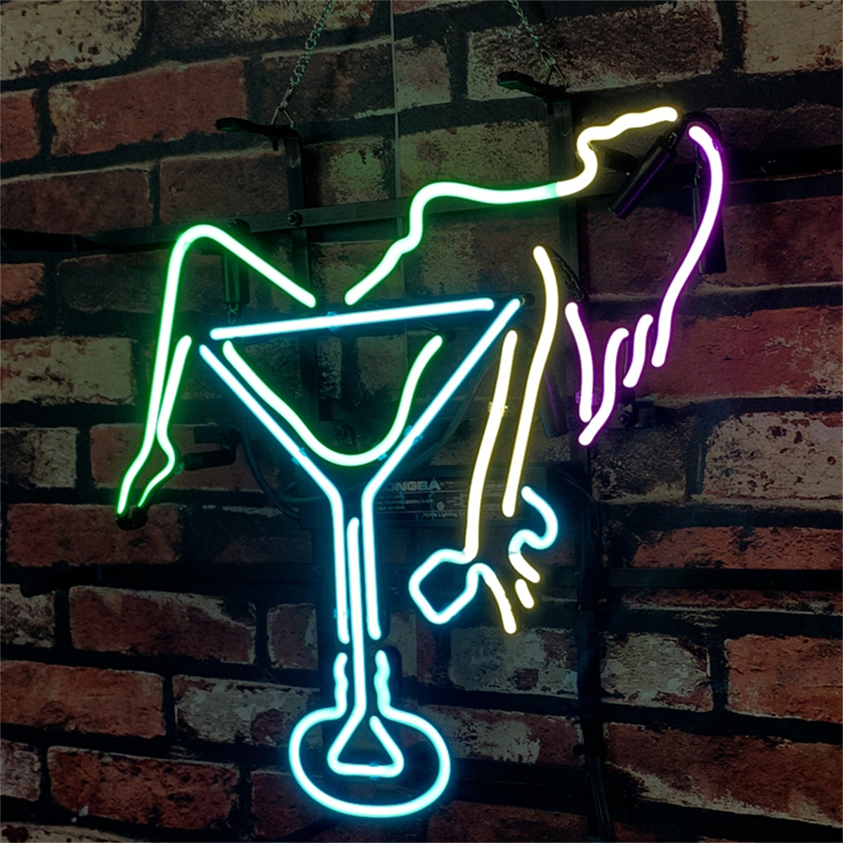 Neon sign depicting a reclining figure in green and yellow neon lines inside a bright blue martini glass against a dark red brick wall background.