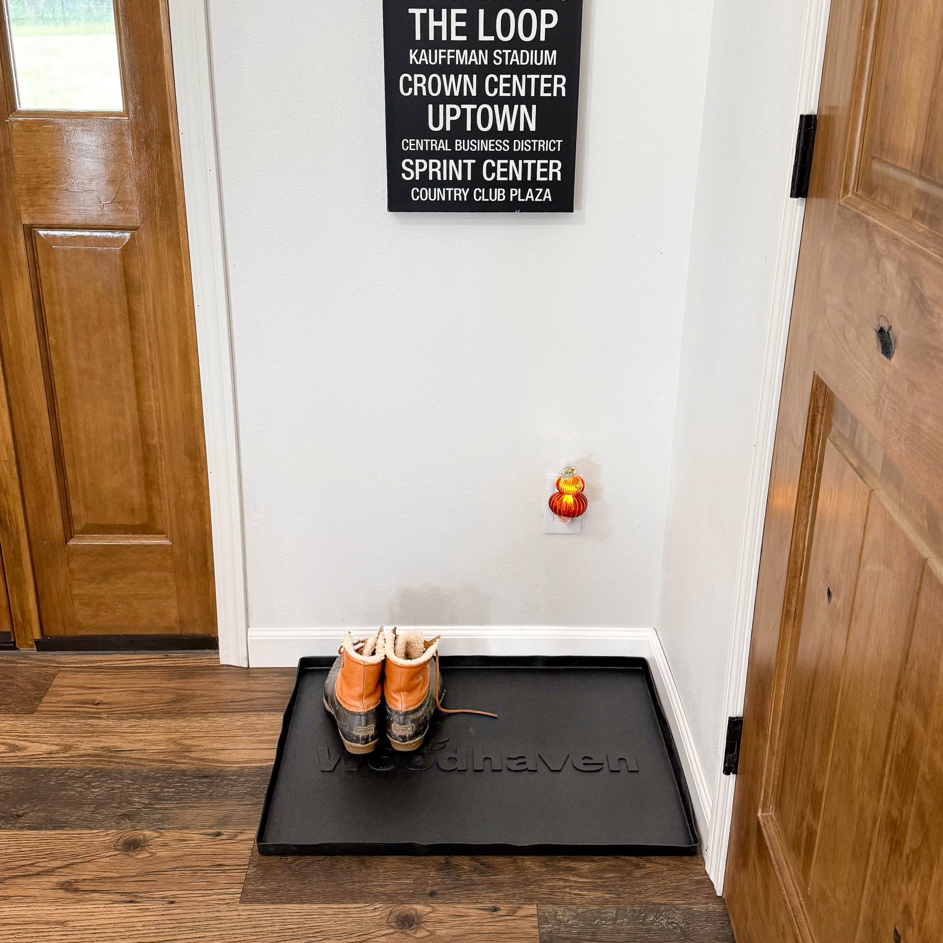 Woodhaven Multi-Purpose Firewood Rack Mat showing raised edges and waterproof surface