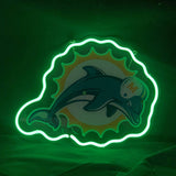 Miami Dolphins logo showing a teal dolphin wearing a white helmet with an orange M, set against an orange sunburst, outlined by a glowing green neon light.