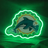 Neon sign featuring the Miami Dolphins logo with a teal dolphin wearing a white helmet with an orange 'M', outlined by a glowing green neon border resembling a sunburst.
