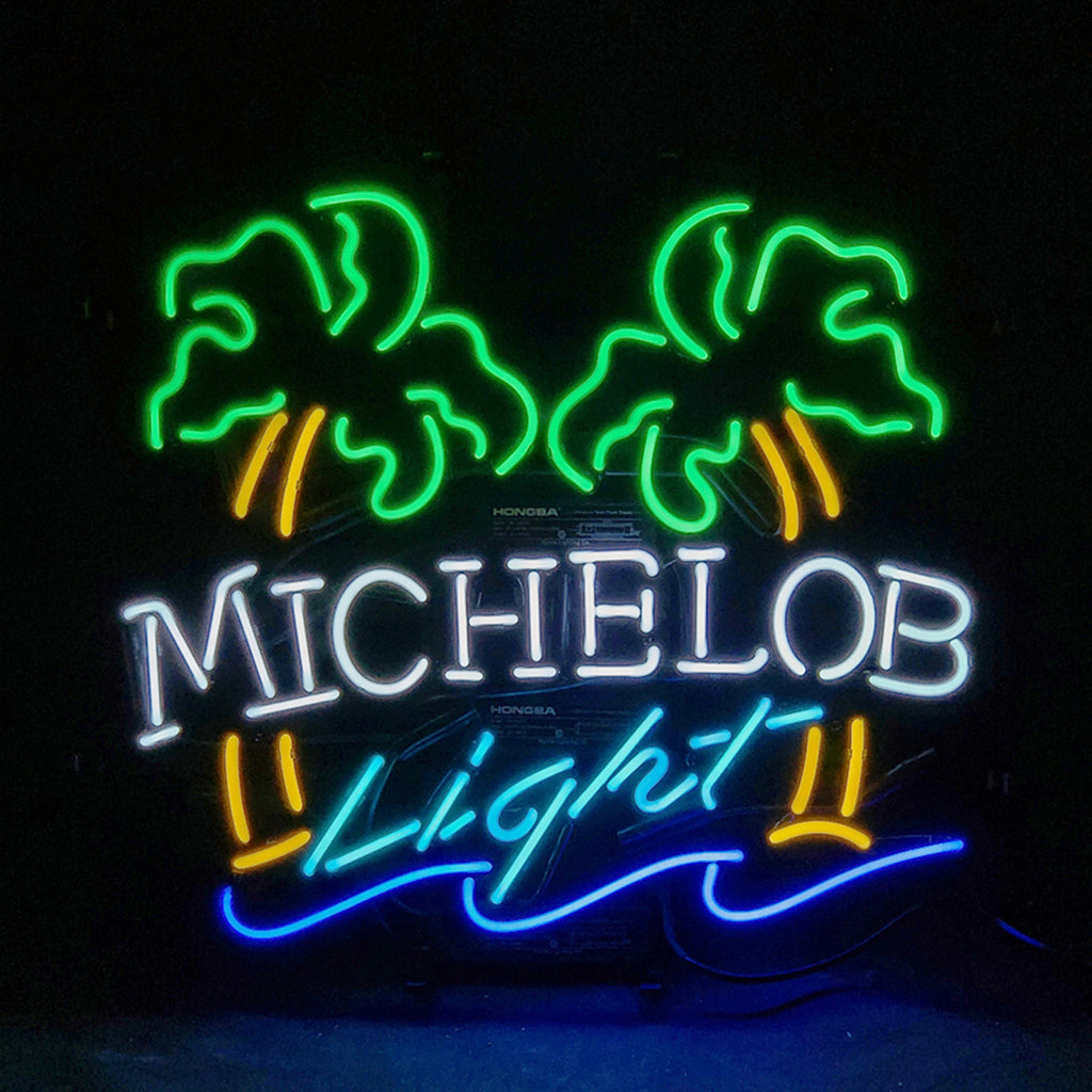 Neon sign with green palm trees, yellow trunks, white 'MICHELOB' text, blue 'Light' script, and a blue wave shape at the bottom against a black background.