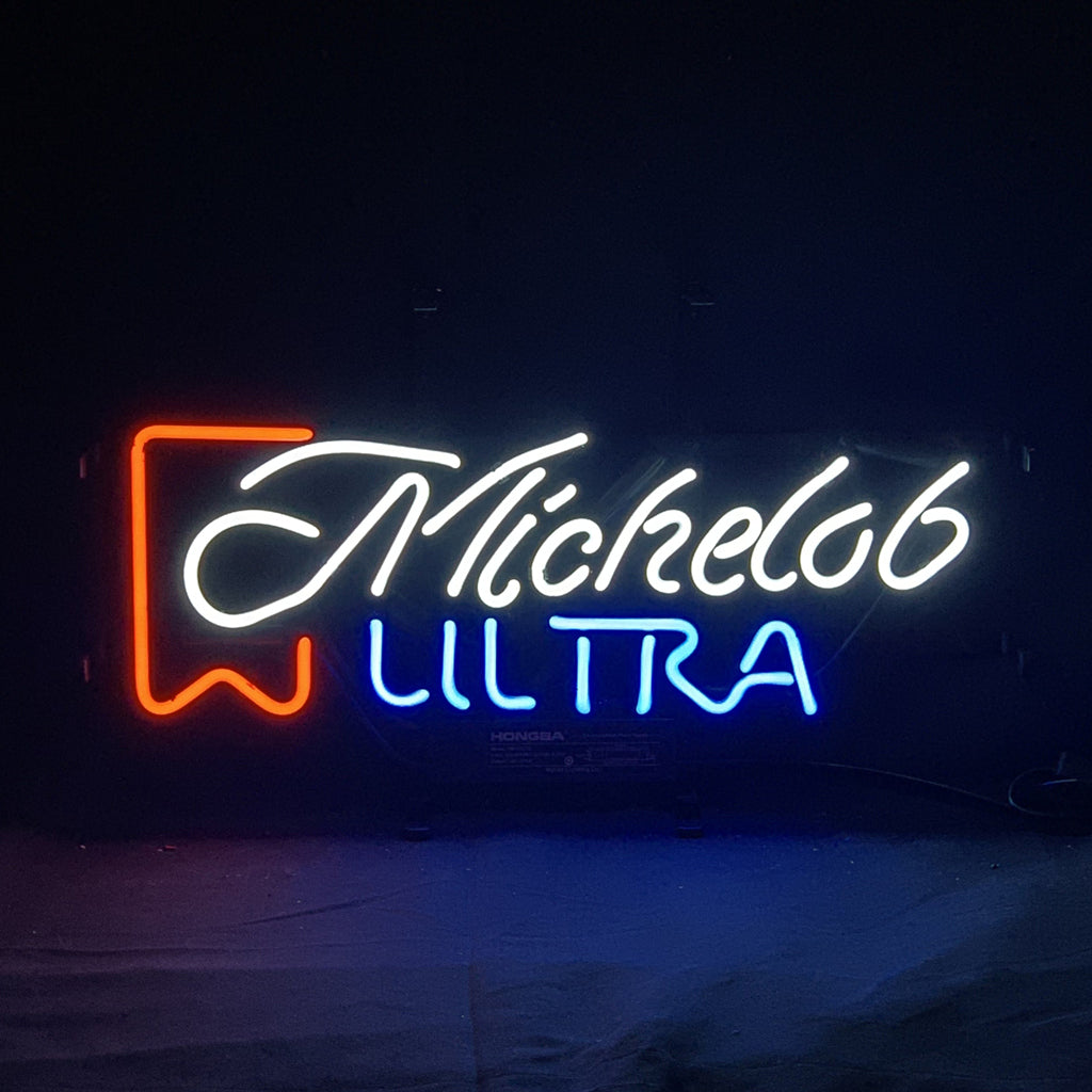 Neon sign with 'Michelob' in white cursive script and 'ULTRA' in blue block letters, accented by a red banner graphic on the left side.