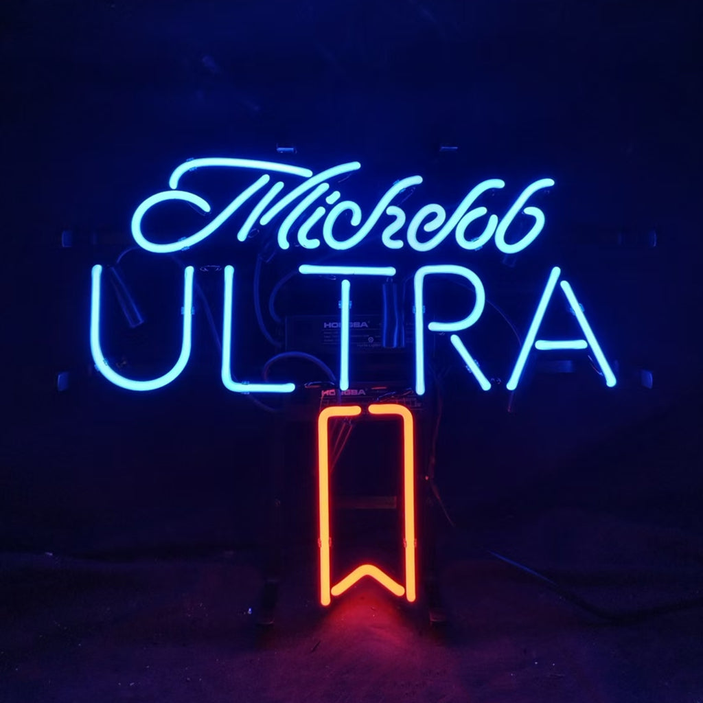 Neon sign displaying 'Michelob' in blue cursive script above bold blue uppercase 'ULTRA' with a downward orange arrow below the text, all against a black background.