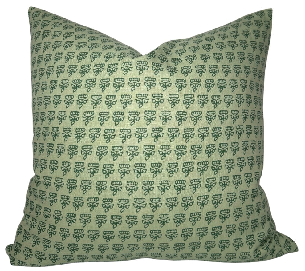Green Mimi Floral Pillow Cover displayed on a couch showing floral front and ivory linen back.