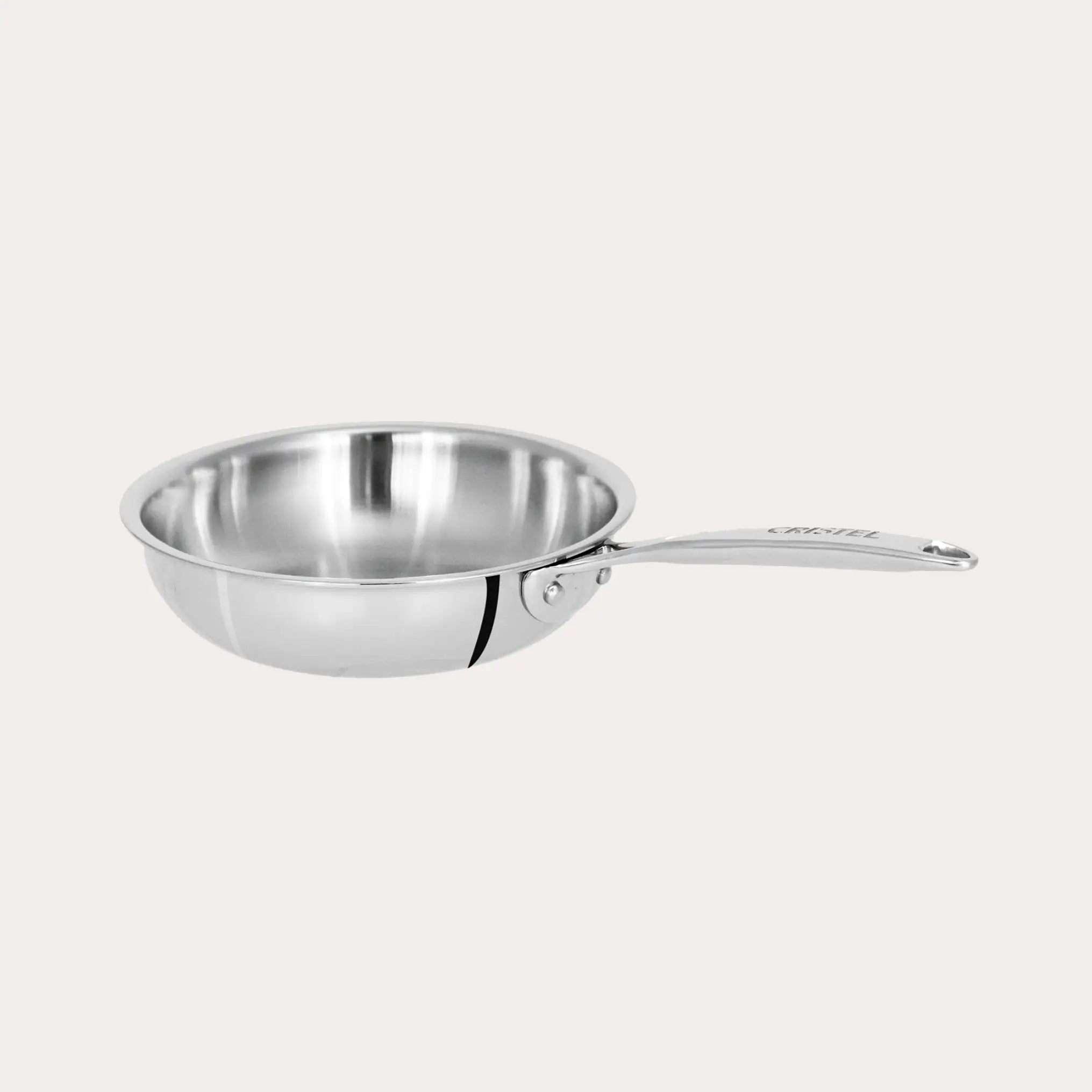CRISTEL USA Mini Frying Pan in three sizes stacked on a wooden countertop