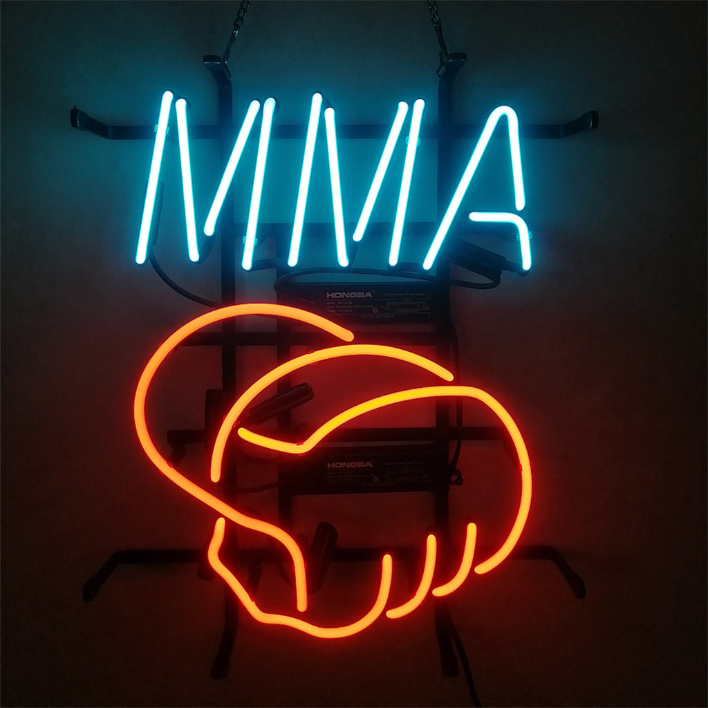 Neon sign with bright blue LED letters 'MMA' above a red outline of two interlocked fists, mounted on a black metal frame against a dark background.