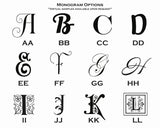 A grid displaying twelve black stylized monogram letter options on white background, each accompanied by double-letter initials beneath, showing diverse decorative fonts.