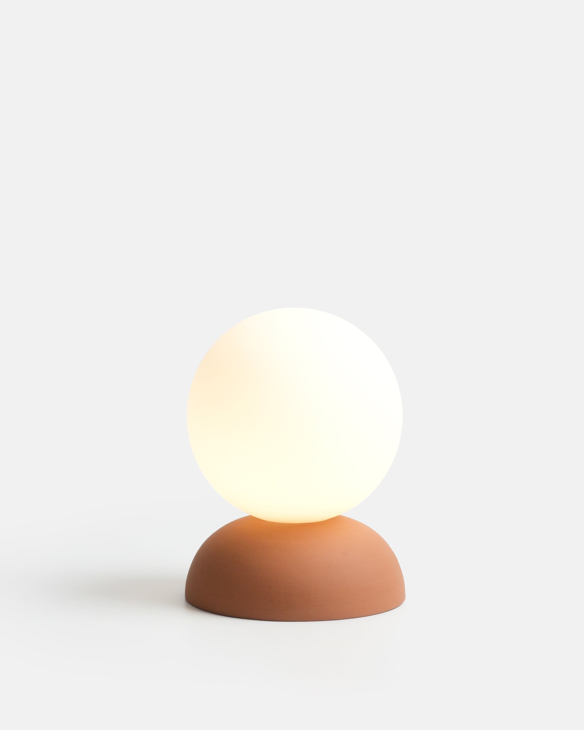 Monroe Table Lamp in Terracotta glaze with round glass globe atop ceramic base