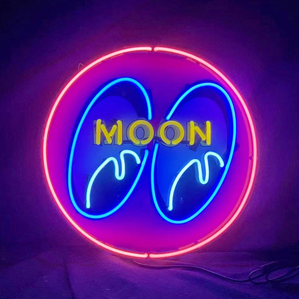 Circular neon sign with pink outer ring, blue stylized eyes inside, and yellow uppercase letters spelling MOON across the eyes on a dark background.