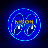 Circular blue neon sign with stylized eyes and dripping design, featuring the word MOON in yellow uppercase letters inside the eyes.