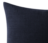 Close-up of a deep midnight blue pillow cover showing a subtle textured weave pattern on smooth fabric with a slightly angled corner.