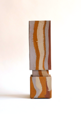Rectangular ceramic vase with a short square base, featuring vertical organic stripes in earthy rust, beige, and white colors against a smooth surface.